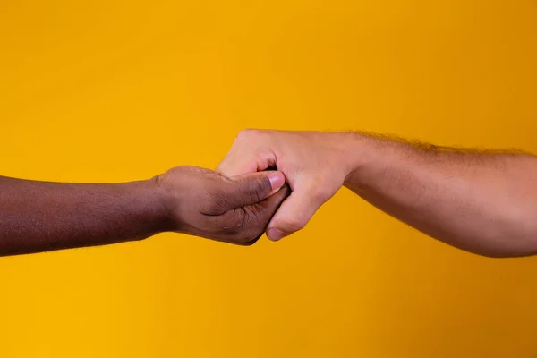 hands of african american and caucasian men