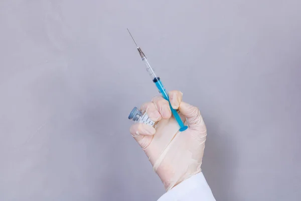nurse holding covid 19 vaccine and syringe. Coronavac. Vaccination against the new Corona Virus Vacine-Covid19: A syringe being drawn up with Vacine-Covid 19.