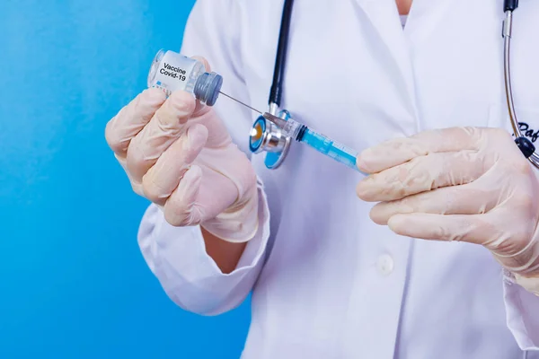 nurse holding covid 19 vaccine and syringe. Coronavac. Vaccination against the new Corona Virus Vacine-Covid19: A syringe being drawn up with Vacine-Covid 19.
