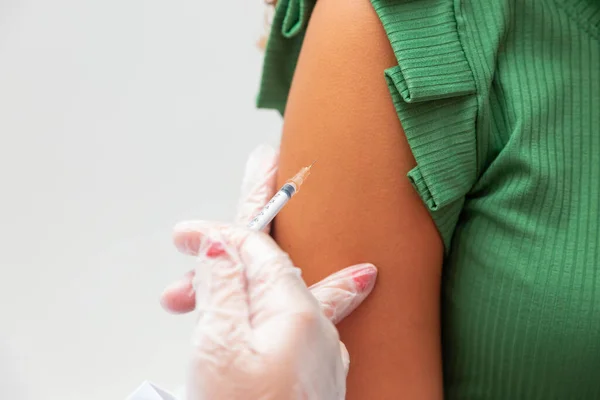 Nurse applying the vaccine against covid 19 and the new variant omicron