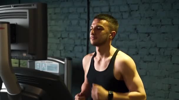 Guy Athlete Runs Treadmill Gym Dark Background — Stock Video