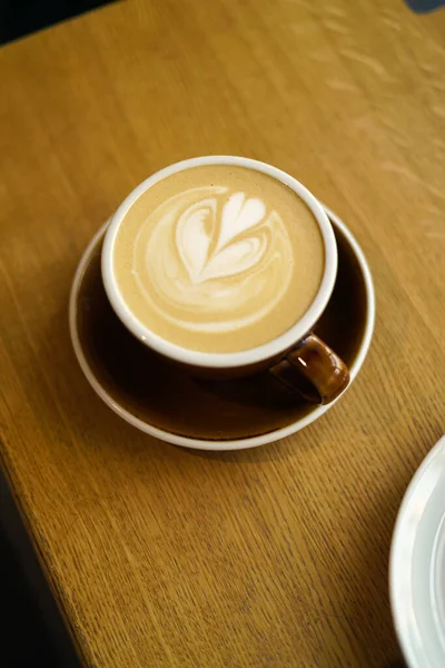 guy holding a cup of coffee in a coffee shop