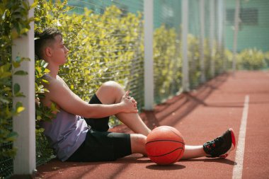 Genç adam basketbol sahasında basketbol oynuyor. Topu ringe fırlattı. Spor yapıyorum. sağlıklı vücut ve sağlıklı yaşam tarzı