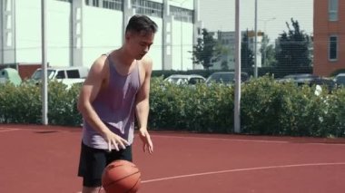 Genç adam basketbol sahasında basketbol oynuyor. Topu ringe fırlattı. Spor yapıyorum. sağlıklı vücut ve sağlıklı yaşam tarzı