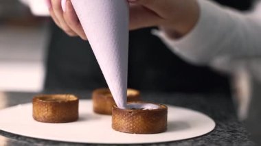 young girl chef makes desserts. bakes sweets and cakes. makes blanks and prepares fruits for the filling. baking, dessert, sweets, complex cooking processes.