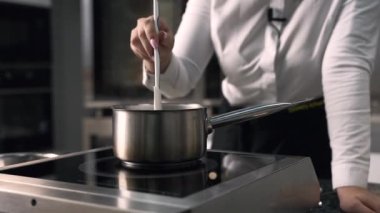 young girl chef makes desserts. bakes sweets and cakes. makes blanks and prepares fruits for the filling. baking, dessert, sweets, complex cooking processes.