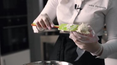 young girl chef makes desserts. bakes sweets and cakes. makes blanks and prepares fruits for the filling. baking, dessert, sweets, complex cooking processes.