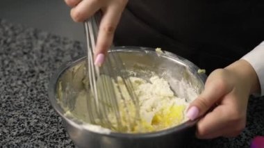 young girl chef makes desserts. bakes sweets and cakes. makes blanks and prepares fruits for the filling. baking, dessert, sweets, complex cooking processes.