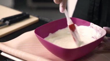 young girl chef makes desserts. bakes sweets and cakes. makes blanks and prepares fruits for the filling. baking, dessert, sweets, complex cooking processes.