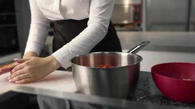 young girl chef makes desserts. bakes sweets and cakes. makes blanks and prepares fruits for the filling. baking, dessert, sweets, complex cooking processes.