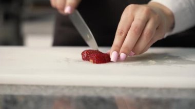 young girl chef makes desserts. bakes sweets and cakes. makes blanks and prepares fruits for the filling. baking, dessert, sweets, complex cooking processes.