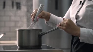 young girl chef makes desserts. bakes sweets and cakes. makes blanks and prepares fruits for the filling. baking, dessert, sweets, complex cooking processes.