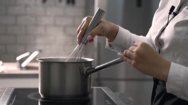 young girl chef makes desserts. bakes sweets and cakes. makes blanks and prepares fruits for the filling. baking, dessert, sweets, complex cooking processes.