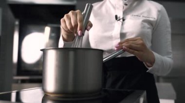 young girl chef makes desserts. bakes sweets and cakes. makes blanks and prepares fruits for the filling. baking, dessert, sweets, complex cooking processes.