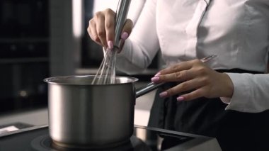 young girl chef makes desserts. bakes sweets and cakes. makes blanks and prepares fruits for the filling. baking, dessert, sweets, complex cooking processes.