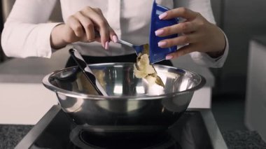 young girl chef makes desserts. bakes sweets and cakes. makes blanks and prepares fruits for the filling. baking, dessert, sweets, complex cooking processes.