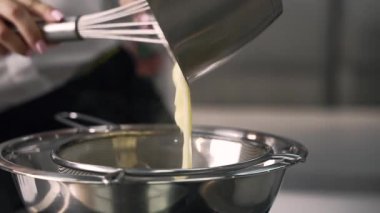 Genç aşçı kız tatlı yapıyor. Tatlı ve kek pişirir. Boşlukları doldurur ve meyveleri hazırlar. Pişirme, tatlı, tatlılar, karmaşık pişirme süreçleri.