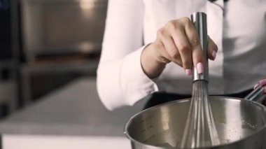 young girl chef makes desserts. bakes sweets and cakes. makes blanks and prepares fruits for the filling. baking, dessert, sweets, complex cooking processes.