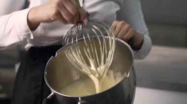 young girl chef makes desserts. bakes sweets and cakes. makes blanks and prepares fruits for the filling. baking, dessert, sweets, complex cooking processes.