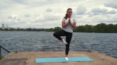sports girl doing stretching near the river