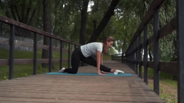 Girl Goes Sports Does Stretching Park Bridge — Stockvideo