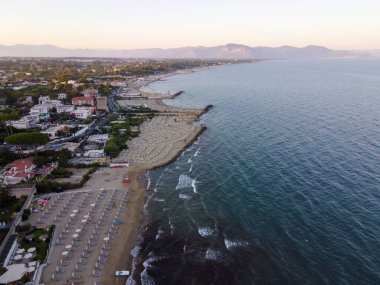 San Felice Circeo 'nun kumlu sahillerinde gün batımında, antik İtalyan şehri Latina' da Tyrhenian Denizi 'nde, turistler yaz tatilinde