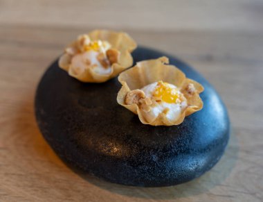 Modern restoranda siyah taşta servis edilen lezzetli vejetaryen aperatifleri.