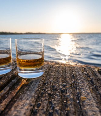 Gün batımında İskoç viskisi içmek deniz, okyanus veya nehir manzaralı, İskoçya, İngiltere 'de özel viski imalathanesi turları