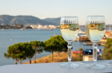 Fransız Rivierası 'nda yaz mevsimi, Cotes de Provence' den soğuk beyaz şarap içmek açık teraslarda Toulon, Var, Fransa limanı manzaralı.