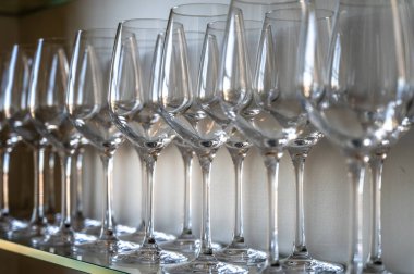 Restorandaki raflarda bir sürü boş temiz şarap ve tatlı şarabı kadehi var.