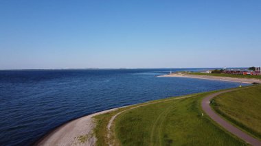 Güneşli bir günde Wemeldinge, Zeeland, Hollanda 'daki evler ve su manzarası