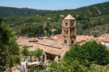 Fransa 'nın Provence kentindeki Moustiers-Sainte-Marie kasabasındaki dağlık uçurum, eski evler, yeşil vadi. Turistik bir yer.