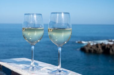 Tenerife, Kanarya Adaları 'nda mavi Atlantik Okyanusu manzaralı soğuk verdejo beyaz şarap içmek