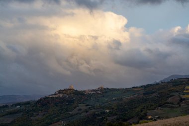 Val d 'Orcia tepelerinde Bagno Vignoni, Toskana, İtalya yakınlarında. Selvi ağaçları, üzüm bağları, ormanlar ve bulutlu sonbaharda sürülen tarlalarla Toskana manzarası.