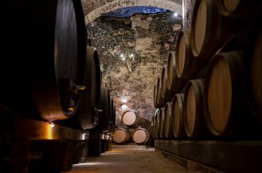 İtalya 'nın Toskana kentindeki Montepulciano Tepesi' nde şarap nobile di Montepulciano 'nun yaşlanması için eski kırmızı şarap fıçılarıyla ortaçağ yeraltı şarap mahzenleri.