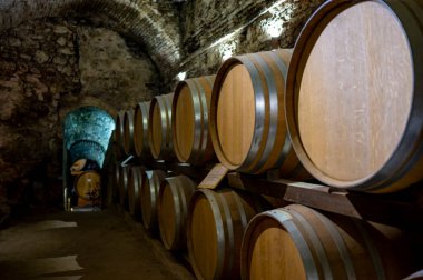 İtalya 'nın Toskana kentindeki Montepulciano Tepesi' nde şarap nobile di Montepulciano 'nun yaşlanması için eski kırmızı şarap fıçılarıyla ortaçağ yeraltı şarap mahzenleri.