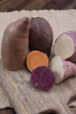 Renkli kök sebzeler pembe, mor ve turuncu organik tatlı patatesler yakın çekim