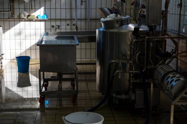 İtalya 'nın Parma kentindeki küçük peynir çiftliğinde sabahın erken saatlerinde taze, yumuşak ricotta peyniri yapma süreci.
