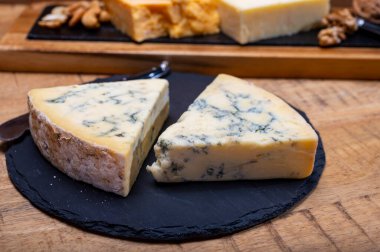 İngiliz peynirleri koleksiyonu, mavi Stilton, İskoç renkli ve İngiliz olgun çedar peynirleri.