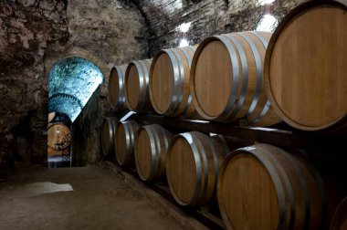 İtalya 'nın Toskana kentindeki Montepulciano Tepesi' nde şarap nobile di Montepulciano 'nun yaşlanması için eski kırmızı şarap fıçılarıyla ortaçağ yeraltı şarap mahzenleri.