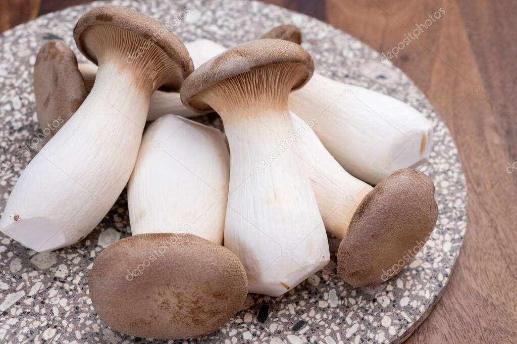 Tasty vegetarian food, fresh organic Pleurotus eryngii king trumpet mushrooms  close up