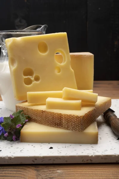 Swiss cheese collection, holes emmentaler and gruyere cheese made from unpasteurized cow\'s milk close up