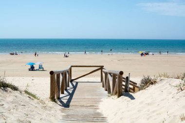 Golden sandy beaches near Sanlucar de Barrameda, small Andalusian town, Spain in summer clipart