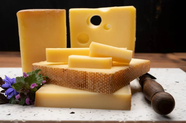 Swiss cheese collection, holes emmentaler and gruyere cheese made from unpasteurized cow\'s milk close up