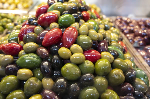 Colorful olives close up on market, healthy vegetarian food background