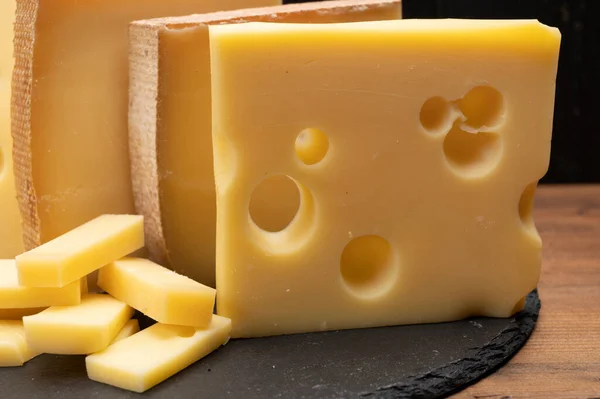 Swiss cheese collection, emmentaler with holes,  gruyere, appenzeller fondue cheeses close up