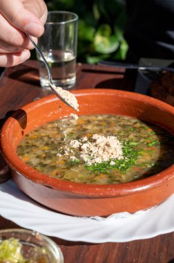 Tenerife 'deki tipik bir Kanarya Adası işletmesi olan Guachinche' de akşam yemeği, yerel olarak üretilen beyaz veya kırmızı şarap ile birlikte güneşli bir günde ev yapımı geleneksel yemekler sunuluyor, gofio ile sebze çorbası.