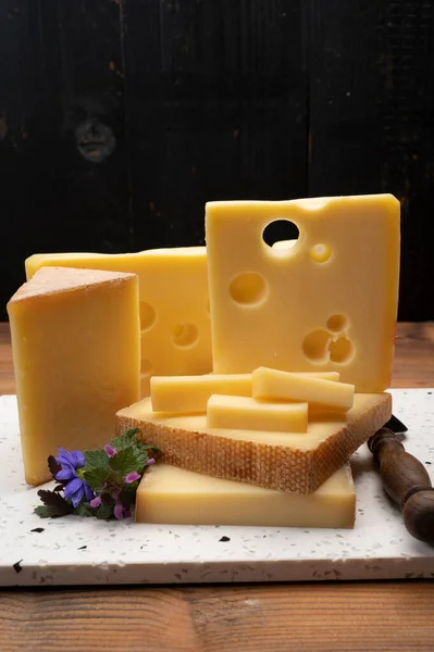 Swiss cheese collection, holes emmentaler and gruyere cheese made from unpasteurized cow\'s milk close up