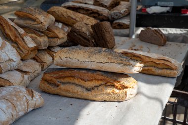 Doğal mayayla yapılan ekşi hamurlu biyolojik ekmek ve Provence, Fransa 'da pazarda satılmak üzere odun sobasında pişirildi.