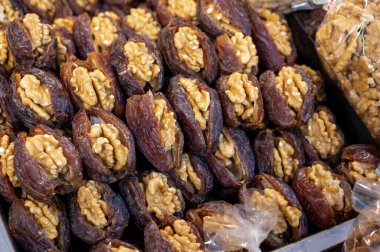 Turkish or arabic sweet dessert, ripe dried dadels with walnuts sweetened with syrup or honey, close up